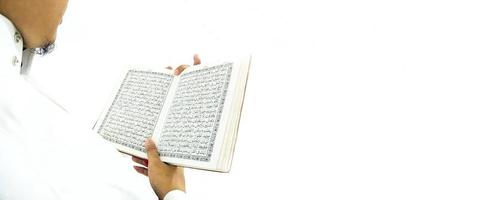 Man Holding and reading quran. Islamic Background photo