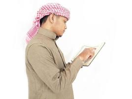 Man Holding and reading quran. Islamic Background photo