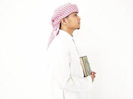 Man Holding and reading quran. Islamic Background photo