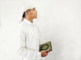 Man Holding and reading quran. Islamic Background photo