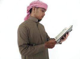 Man Holding and reading quran. Islamic Background photo