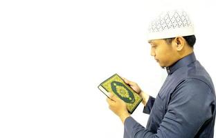 Man Holding and reading quran. Islamic Background photo