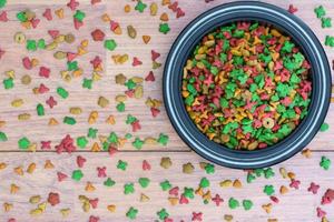 Cat food in bowl on wooden background photo