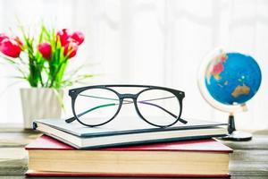 Eye glasses are placed on books photo