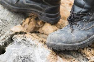 Trekking leather boot on the rock photo