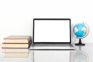 Laptop mockup and book on table photo