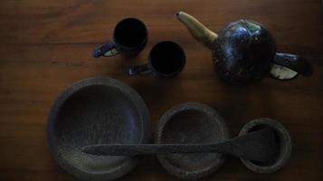 Teapot and teacup on a wooden table in the garden photo