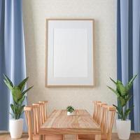 A set of tables and chairs in the room with a picture frame attached to wall. photo