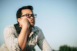 Young Asian Businessman with problems and stress outside corporate office photo