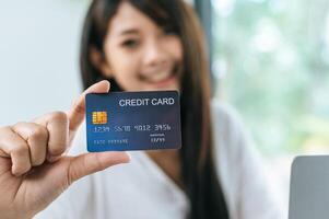 Young businesswoman paying order having contactless payment with cardit card photo