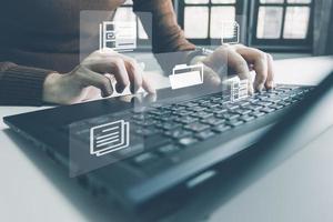 Officer using laptop manage files, Document Management System DMS, Online document database management, automated processes to manage system, ERP enterprise efficient, business technology. photo