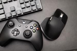 Samutprakarn Thailand Jan 23 2023 Hand holding Wireless gamepad for the Xbox One a home video game console produced by Microsoft. Black Xbox game controller. photo