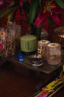 Bandung, Indonesia, 2020 - The offerings like food and candle on the top of the red Buddhist table during the praying from the monks photo