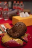 Bandung, Indonesia, 2020 - The offerings like food and candle on the top of the red Buddhist table during the praying from the monks photo