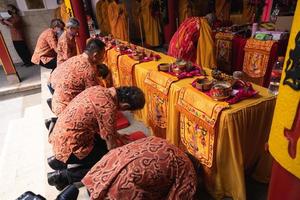 Bandung, Indonesia, 2020 - the congregation praying together at the Buddhist altar with the monks photo