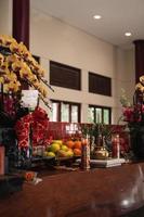 Bandung, Indonesia, 2020 - The offerings like food and candle on the top of the red Buddhist table during the praying from the monks photo