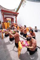 Bandung, Indonesia, 2020 - the congregation praying together at the Buddhist altar with the monks photo