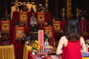 Bandung, Indonesia, 2020 - The visitor praying together with the monks in front of the offerings to the god photo