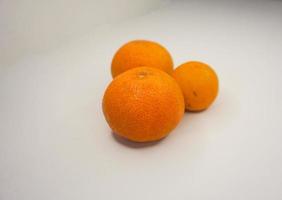 Orange fruit Closeup shot of natural mandarin orange fruit, isolated on white background. photo