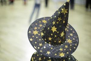 Wizard hat. Child at holiday. Cap on head. Details of children's play. photo