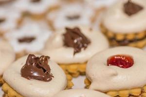 tasty fresh christmas cookies with nougat and white foam detail view photo