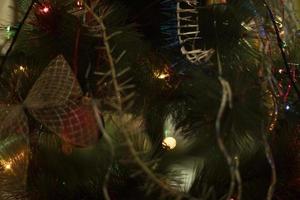Christmas decorations on Christmas tree. Garlands of house. Cozy atmosphere. photo
