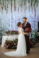 portrait of a young couple of newlyweds in wedding looks photo