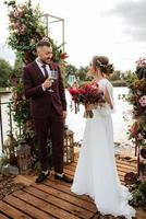 wedding ceremony of the newlyweds on the pier photo