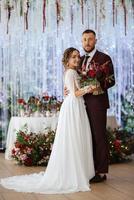 portrait of a young couple of newlyweds in wedding looks photo