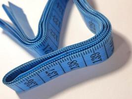 Isolated white photo of a sewing meter or fabric meter in blue.