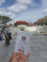 Yogyakarta, Indonesia in November 2022. A hand is holding a ticket to enter the Fort Vredeburg Museum. photo