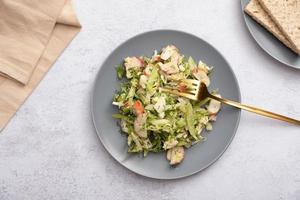 Top view salad of fresh vegetables and crab sticks in a plate. The concept of healthy eating photo