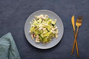 Top view salad of fresh vegetables and meat in a plate. The concept of healthy eating photo