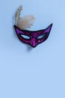 Festive face masks for carnival or masquerade celebration on colored background flat lay, top view photo