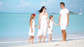 Young beautiful family on white beach video