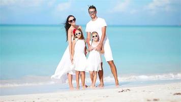 Young family having fun on white tropical caribbean beach video