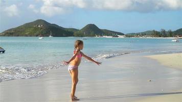 Sihouette of little girl dancing on the beach at sunset. video