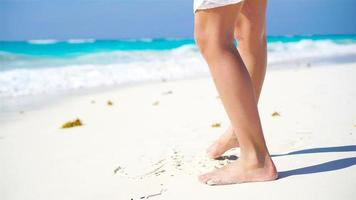 Close up kids feet walking barefoot on the beach. video