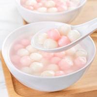 Tang yuan, tangyuan, delicious red and white rice dumpling balls in a small bowl. Asian traditional festive food for Chinese Winter Solstice Festival, close up. photo