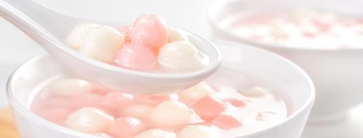 Tang yuan, tangyuan, delicious red and white rice dumpling balls in a small bowl. Asian traditional festive food for Chinese Winter Solstice Festival, close up. photo