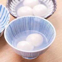 Tang yuan, tangyuan, yuanxiao in a small bowl. Delicious asian traditional festive food rice dumpling balls with stuffed fillings for Chinese Lantern Festival, close up. photo