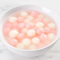Tang yuan, tangyuan, delicious red and white rice dumpling balls in a small bowl. Asian traditional festive food for Chinese Winter Solstice Festival, close up. photo