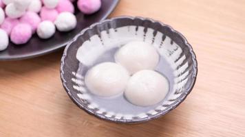 Tang yuan, tangyuan, yuanxiao in a small bowl. Delicious asian traditional festive food rice dumpling balls with stuffed fillings for Chinese Lantern Festival, close up. photo
