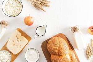 festive background to the celebration of the spring Jewish shavuot. traditional treats and symbols of the holiday. top view. flat styling. photo