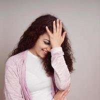 embarrassed young woman facepalm photo