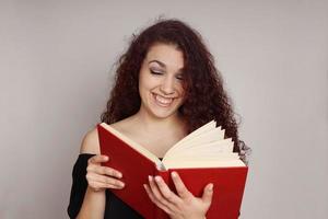 girl reading a funny book photo