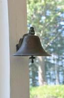 Stunning Metal Brass Bell Hanging on a Porch photo