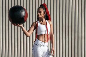 Middle plan. Athletic woman with med ball. Strength and motivation.Photo of sporty  woman in fashionable sportswear photo