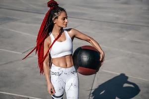 Athletic woman with med ball. Strength and motivation.Photo of sporty  woman in fashionable sportswear photo