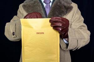 Portrait of Man in Fur Coat and Leather Gloves Reaching Into Confidential Envelope. Film Noir Secret Agent Spy. Identity Theft and Crime. photo